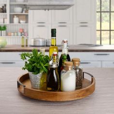 an assortment of condiments are arranged on a tray in the middle of a kitchen