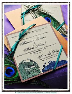 peacock feathers are tied to the wedding stationery