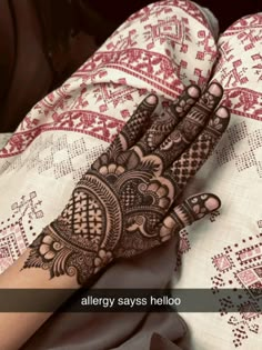 a woman's hand with henna on it and the words, allergy says hello