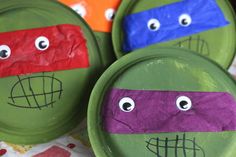 three paper plates decorated to look like teenage mutant turtles with googly eyes on them