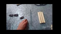 a person is working on some kind of crafting project with wood and metal rods