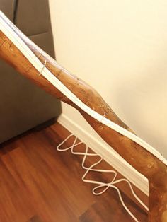 a large wooden object sitting on top of a hard wood floor next to a wall