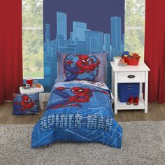 a bed room with a spiderman comforter and two nightstands next to it