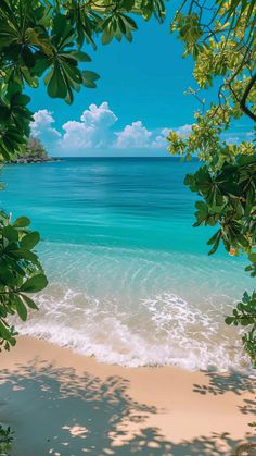 the beach is clear and blue with waves coming in from the water's edge