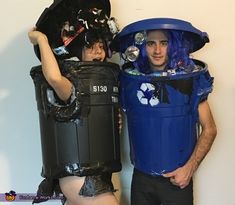 two people dressed up in costumes standing next to each other with trash cans on their heads