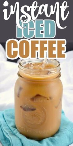 a mason jar filled with iced coffee sitting on top of a blue towel