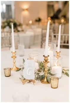 a table with candles and place settings on it