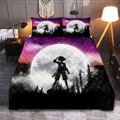 a bed covered in a purple and black comforter next to a night sky with trees