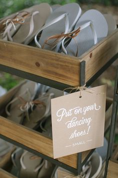 a sign that says put on your dancing shoes hanging from a rack filled with pairs of slippers