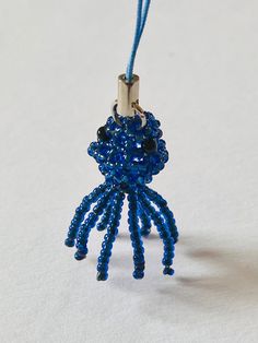 a blue beaded keychain hanging from a cord