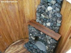 an outdoor toilet made out of rocks and wood