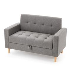 a gray couch sitting on top of a white floor