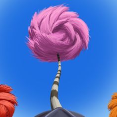 an animated image of a pink hairball flying through the air with other fluffy objects around it