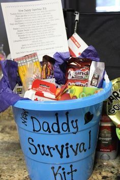 a blue bucket filled with candy and candies sitting on top of a granite counter