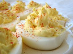 deviled eggs are sitting on a white plate