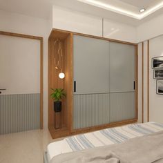 a bed sitting under a window next to a wall mounted cabinet and potted plant