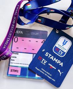 luggage tags and lanyards are laid out on a white surface with a blue lanyard