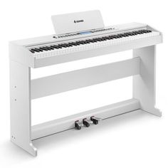 a white piano sitting on top of a wooden stand with an electronic keyboard attached to it