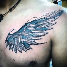 a man's chest with an artistic tattoo design on the top half of his chest