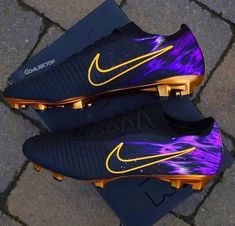 the purple and gold nike soccer cleats are on display