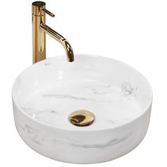 a white marble sink with gold faucet