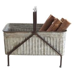 an old fashioned metal tub with several pieces of wood in it