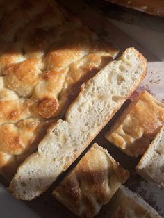 several pieces of bread sitting on top of a cutting board