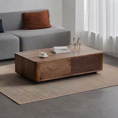 a living room with a couch, coffee table and rug