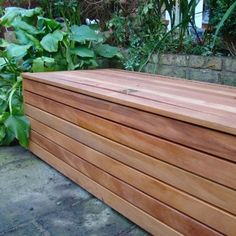 a large wooden box sitting in the middle of a garden