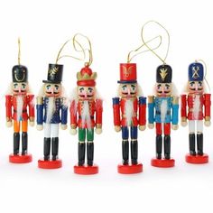 four wooden nutcrackers are lined up together