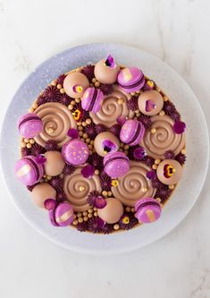 a white plate topped with a cake covered in chocolate and candies on top of it