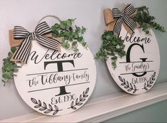 two wooden signs are decorated with greenery and bow ties on the mantels