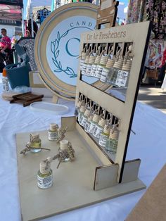 a display case with many bottles and spoons on it in front of a sign