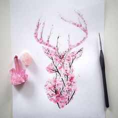 a drawing of a deer's head with pink flowers on it next to a pair of scissors