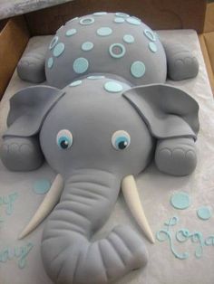 an elephant shaped cake sitting on top of a table