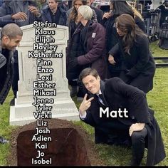 a man kneeling in front of a grave with the names of people around him on it