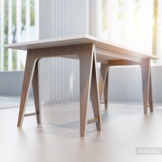 two wooden tables sitting next to each other on top of a hard wood floor in an empty room