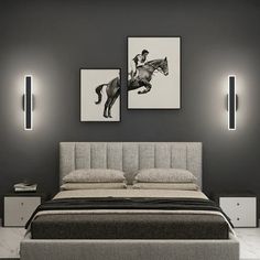 a bed with two pictures on the wall above it