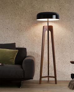 a floor lamp next to a couch in a living room