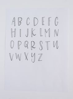 a white piece of paper with the letters drawn on it and some type of writing