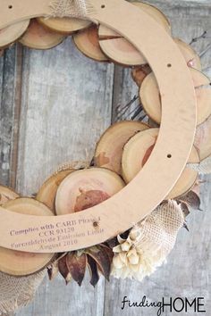 a wreath made out of wood slices and burlocks with the words, come with us on it