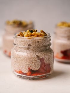 three jars filled with food sitting on top of a table