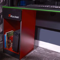 a red computer desk with a keyboard and magazine rack on it's left side