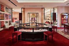 the inside of a jewelry store with red carpeting and lots of glass cases on display