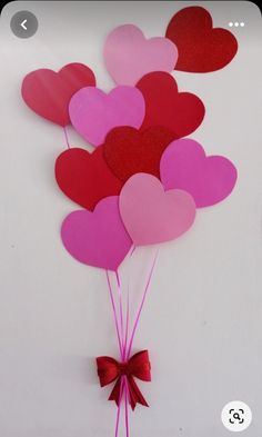 valentine's day heart balloons are hanging on the wall