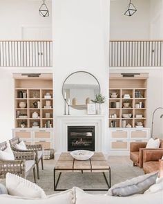 a living room filled with furniture and a fire place in front of a white fireplace