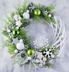 a christmas wreath with green and white ornaments