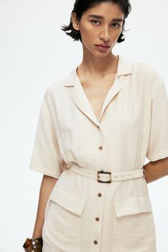 Short dress in an airy  woven viscose blend. Resort collar  buttons at front  and an eyelet belt at waist with a rectangular buckle. Gently dropped shoulders  elbow-length sleeves  and patch front pockets with flap. Unlined. Eyelet Belt, Cargo Dress, Elbow Length Sleeve, Light Beige, Short Dress, Short Dresses, H&m, Buckle, Collar