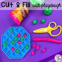 play dough and scissors on a purple tray with the words cut & fill with playdough