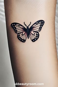 a small butterfly tattoo on the side of a woman's leg, it is black and white